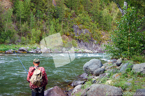 Image of Fisherman on clean mountain river year daytime