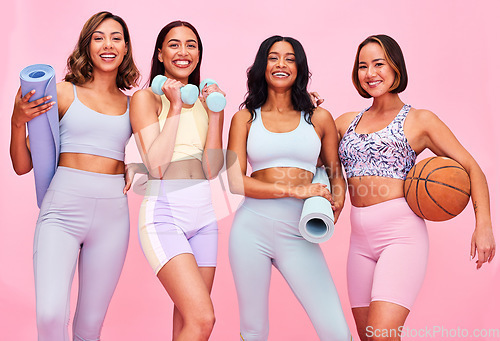 Image of Fitness, girl friends and happy portrait with fitness, workout and sport training gear in studio. Women, diversity and group with pink background and smile with exercise and healthy body wellness