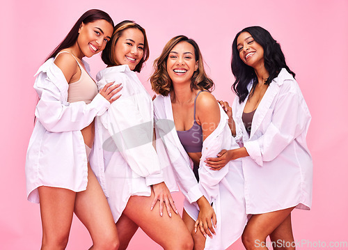 Image of Women, friends and smile portrait in studio with beauty, diversity and white shirt with female community. Pink background, bonding and young model group together with inclusion, happy and wellness