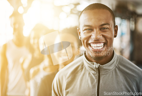 Image of Fitness, black man and portrait with team, workout class and training in a health and wellness club. Lens flare, happy and smile with diversity and personal trainer with exercise, sports and group