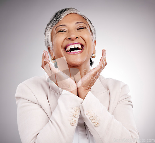 Image of Funny, portrait and beauty of mature woman in suit in studio isolated on a white background. Face hands, makeup cosmetics and excited model with laugh in spa facial treatment for skincare antiaging