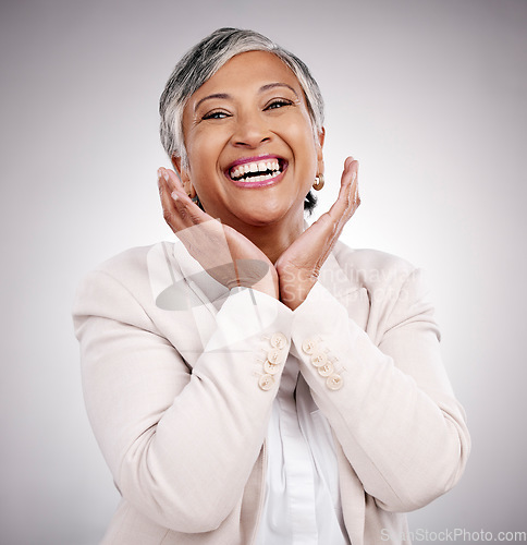 Image of Portrait, hands and beauty of mature woman in suit in studio isolated on a white background. Face, makeup cosmetics and excited model with funny laugh in spa facial treatment for skincare antiaging