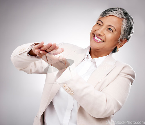 Image of Smile, money gesture and senior woman in a studio with cashback, prize or financial freedom. Happy, excited and elderly female model with finance hand sign or emoji for savings by a gray background.