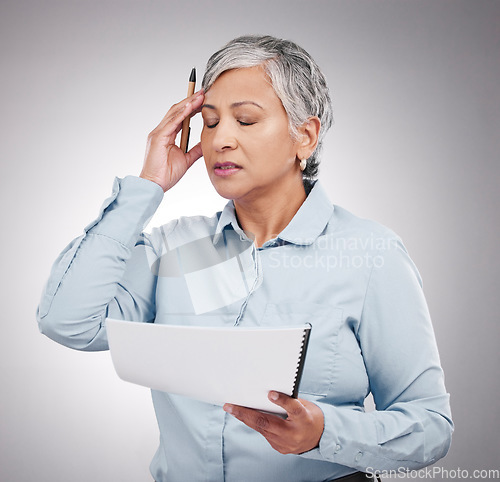 Image of Business woman, headache and stress for documents, financial paperwork and taxes, audit or debt in studio. Professional manager or mature person in pain or frustrated for budget on a white background