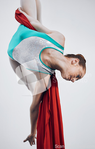 Image of Aerial, woman gymnast and dance performance with stretching, flexibility and athlete with white background. Workout, exercise and gymnastics with balance, art and girl with acrobat competition