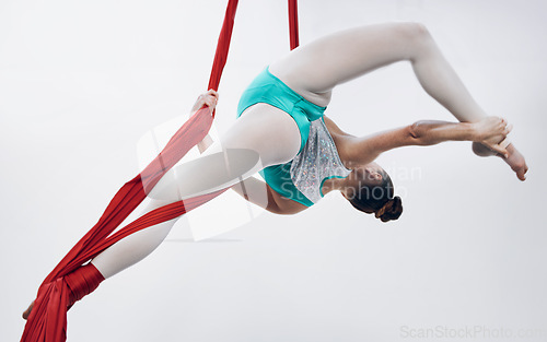 Image of Gymnastics, woman acrobat with performance and muscle, sports and art with athlete on white background. Gymnast, sports and exercise with creativity, talent with fabric and competition in studio