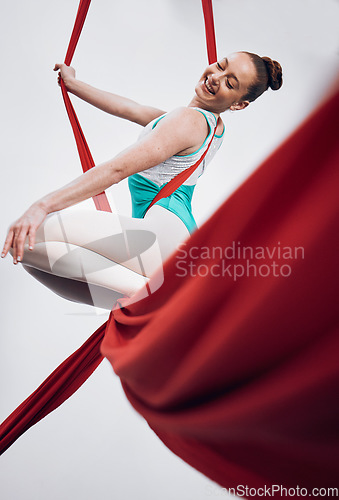 Image of Gymnastics, performance and happy woman in sports competition for professional fitness challenge or dancing. Professional, healthy and athlete with balance on silk isolated in studio white background