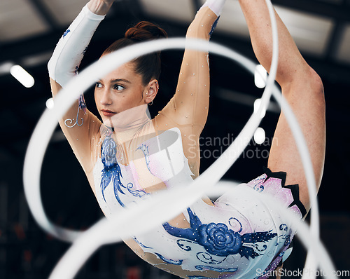 Image of Woman, ribbon gymnastics and dancing for sports performance, competition and concert in arena. Dancer, rhythm and creative training of athlete with talent, balance and flexibility for agile contest