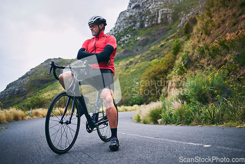 Image of Fitness, cycling and thinking with man on bike in nature for sports, training and challenge. Exercise, workout and health with mature person on bicycle in mountains for energy, freedom or performance