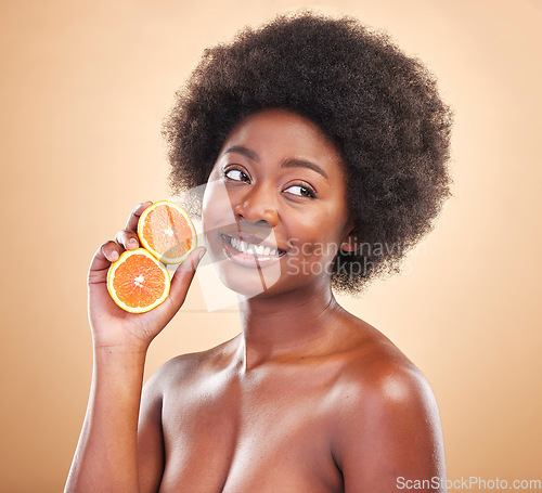 Image of Orange, natural skincare and woman on studio background for healthy cosmetics, vegan benefits or nutrition. Happy african beauty model thinking of citrus fruits for vitamin c, diet or eco dermatology