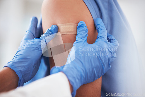 Image of Healthcare, vaccine and plaster on arm of person in hospital for covid, flu or immunization closeup, Doctor, hands and zoom on patient at a clinic for medical, consultation and disease vaccination