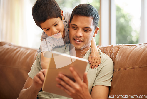 Image of Father, boy and child with tablet on sofa for online games, reading ebook story and elearning multimedia. Man, dad and happy kid streaming cartoon, movies or digital technology in living room at home