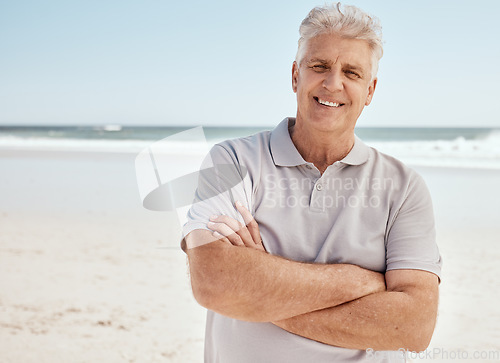 Image of Beach portrait, arms crossed and senior man relax with summer sunshine, nature freedom or travel holiday in Australia. Morning fresh air, ocean and mature person smile for retirement vacation getaway