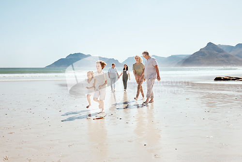Image of Family holding hands on beach, generations and travel with grandparents, parents and kids outdoor. Happiness, adventure and sea with love and care, people on vacation with trust and support in nature