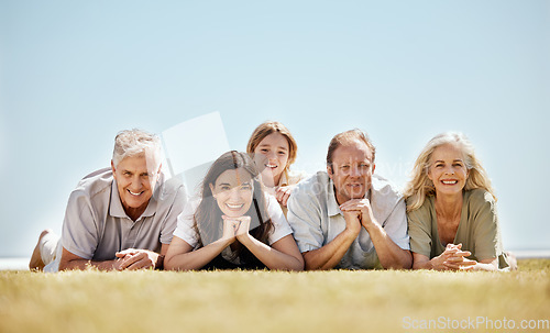 Image of Family, generations and portrait, people outdoor on lawn with grandparents, parents and child. Happiness, people relax in nature while on vacation with mockup space, bonding with love and care,