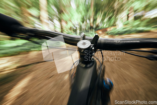 Image of POV, mountain bike and person cycling in nature, park and forest for adventure, speed and motion blur. Closeup, perspective and bicycle handle for outdoor action, fast power and off road performance