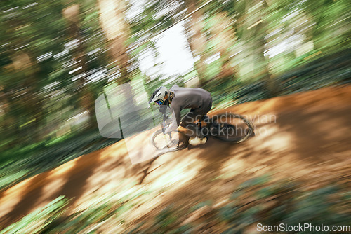 Image of Bicycle, man and forest speed blur for workout outdoor in woods for healthy body. Mountain bike, nature and athlete training, cycling fast or off road adventure on journey, exercise or sport travel