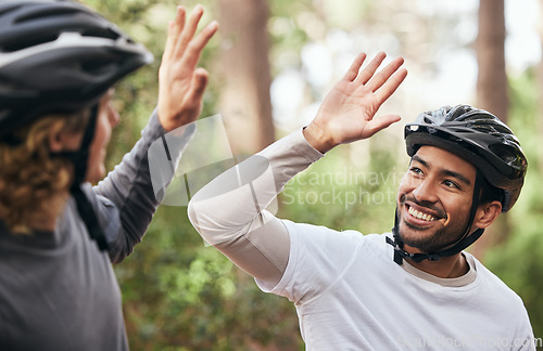 Image of Forest, cyclist and friends with high five, support and exercise with fitness, smile and motivation. People, men and bikers with gesture, woods and challenge with progress, workout and achievement