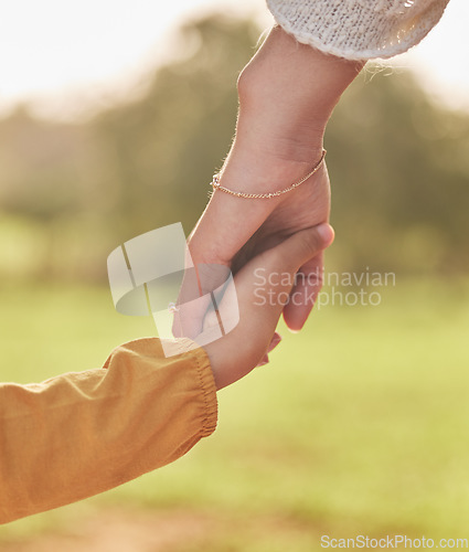 Image of Mother, child and holding hands for walking in park for support, trust and care together or bonding in nature. Love, comfort and parent help kid in the morning sunshine with kindness on weekend