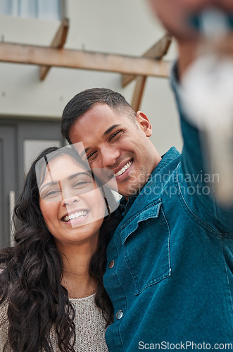Image of Happy couple, portrait and real estate with keys to home, new building or property investment together. Man and woman or homeowners smile for moving in, buying or asset loan in finance and investing