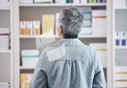 Image of Patient, pharmacy and checking pharmaceutical shelf for medication, healthcare or boxes at the drugstore. Rear view of customer in search for medical product, supplements or antibiotics at the clinic