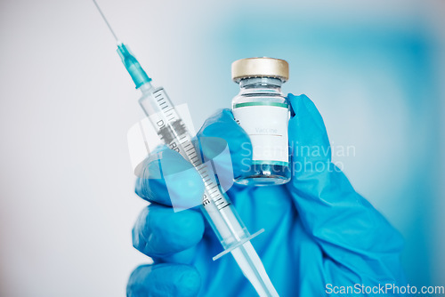 Image of Hand, vaccine and syringe with a doctor in the hospital closeup for healthcare or medication. Medical, injection and treatment with a medicine professional in a clinic for innovation or cure