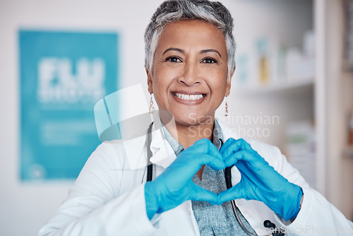 Image of Senior, happy woman and portrait of doctor with heart hands in healthcare, service or love at hospital. Mature female person or medical professional smile in happiness, like emoji or sign at clinic