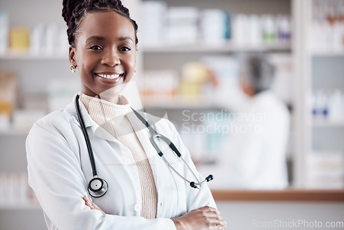 Image of Black woman, doctor in portrait with arms crossed and healthcare, medical professional and hospital dispensary. Pharmacy, health and confidence, smile with wellness and drugs, medicine and service