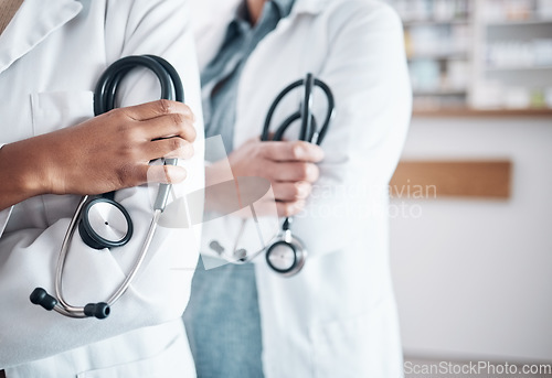 Image of People, doctor and hands of professional with stethoscope in healthcare, pharmaceutical or help at pharmacy. Closeup of medical experts with arms crossed in confidence for health service at drugstore