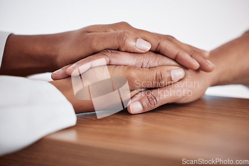 Image of Healthcare, empathy and doctor holding hands with patient for support, compassion or trust. Sympathy, career and closeup of medical worker comforting a person after diagnosis in a medicare clinic.