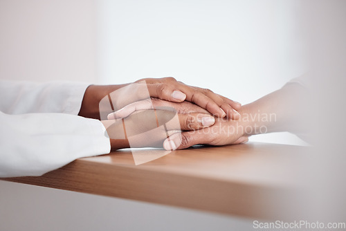 Image of Medical, comfort and doctor holding hands with patient for support, sympathy or unity in clinic. Empathy, care and closeup of healthcare worker consoling person for diagnosis consultation at hospital