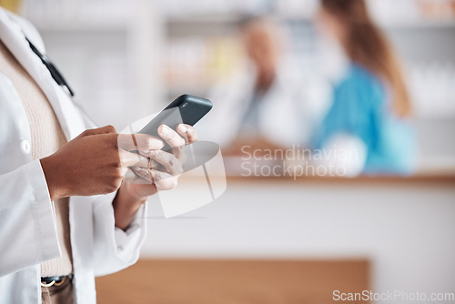 Image of Pharmacist with phone, typing in clinic and medical information research, email or online chat. Smartphone, networking and mockup, woman doctor in pharmacy checking social media or internet news.