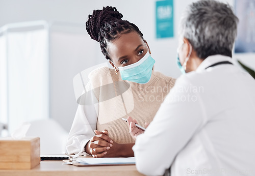 Image of Face mask, help or doctor consulting a patient in meeting in hospital writing history or healthcare record. People, medical or nurse with black woman talking or speaking of test results or advice