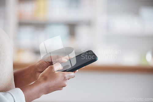 Image of Woman pharmacist with smartphone, typing in clinic and research for medical information, email or online chat. Phone, networking and mockup, doctor in pharmacy checking social media or internet news