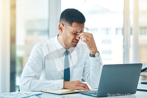 Image of Business man, headache and stress on laptop for financial mistake, accounting error or results and pain. Professional person with glasses, tired and fatigue on computer for research and job report