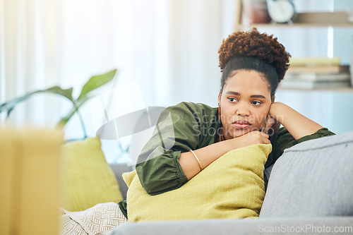 Image of Thinking, tired and black woman on the sofa with depression, anxiety or sad from a breakup. House, young and an African girl on the living room couch with an idea after job fail, mistake or divorce