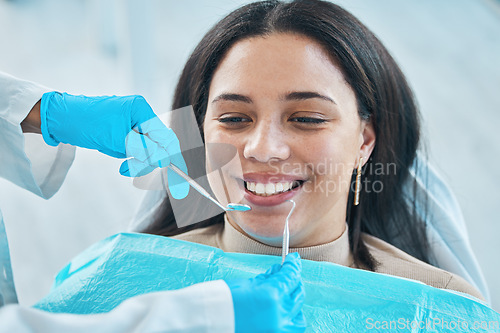 Image of Dentist, hands and patient, woman and teeth whitening, metal tools for dental procedure and healthcare. Smile, tooth decay and veneers treatment, excavator and wellness with oral health at clinic