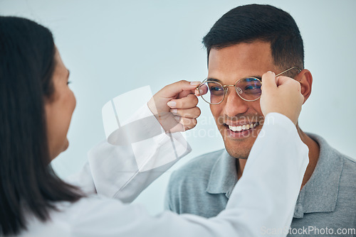 Image of Glasses, eye care and vision, optometrist and patient with help and eyewear choice, prescription and lens. Wire frame, smile and people at optometry clinic during consultation, healthcare and test