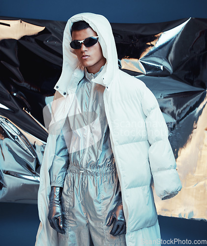 Image of Holographic, vaporwave clothes and man with fashion and futuristic ski style with sci fi in studio. Art, creative and young male model with trendy, cool sunglasses and cyberpunk designer jacket