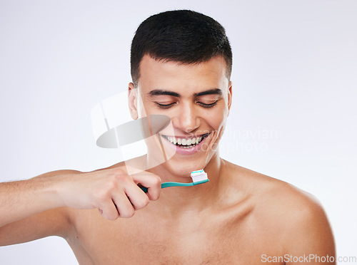 Image of Happy man, toothbrush and dental care in hygiene, grooming or brushing teeth against a white studio background. Male person with big smile or toothpaste in tooth whitening, cleaning or oral treatment