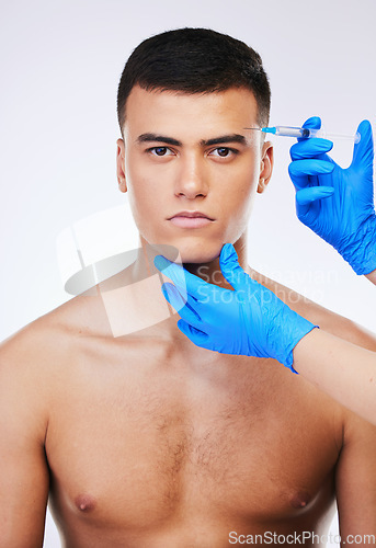 Image of Man, syringe and plastic surgery for eye in studio portrait, doctor and wellness for beauty, change or white background. Young model, needle and hands for face, cosmetic transformation or dermatology
