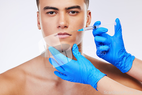 Image of Man, needle and lip filler surgery in studio portrait for beauty, wellness or facial change by white background. Young model, syringe and hands for mouth, cosmetic transformation and dermatology