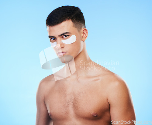 Image of Man, beauty and portrait with eye patch for skincare, grooming and clean with hygiene on blue background. Skin treatment, cosmetics product and wellness, self care and dermatology in a studio