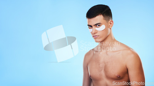 Image of Man, beauty and banner with eye patch for skincare, grooming and clean with hygiene on blue background. Skin treatment, cosmetics product and mockup space, portrait and dermatology in a studio