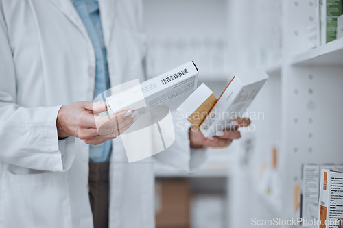 Image of Person, pharmacist and hands with boxes of medication, pharmaceutical or pills on shelf at drugstore. Closeup of medical or healthcare employee with drugs, prescription meds or inspection at pharmacy