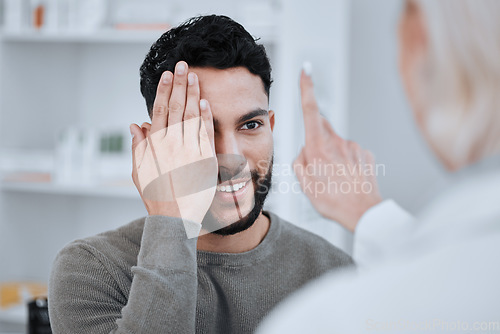 Image of Hand on eye, test and vision, optometrist and patient with health and eyecare, glasses and eyesight exam. Assessment, wellness and man with woman at optometry clinic, help and trust with visual