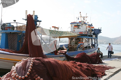 Image of fishermen by the ship
