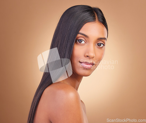 Image of Portrait, hair care and woman with cosmetics, natural beauty and wellness on a brown studio background. Face, person and model with shine, aesthetic and glow with dermatology, texture and volume