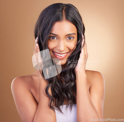 Image of Portrait, hair care and woman with a smile, beauty and cosmetics on a brown studio background. Face, person and model with dermatology, aesthetic or glow with shine, texture and volume with wellness