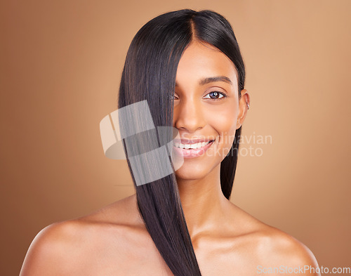 Image of Portrait, hair care and woman with beauty, shine or dermatology on a brown studio background. Face, person or model with aesthetic, grooming or glow with healthy skin, texture or volume with wellness